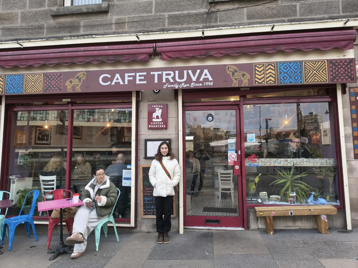 Cafe Truva shopfront on The Shore, Leith — burgundy awnings, Trojan horse sign and kilim-patterned fascia
